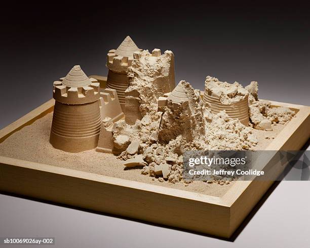 crumbled sand castle in sand box, studio shot - sandbox stock-fotos und bilder