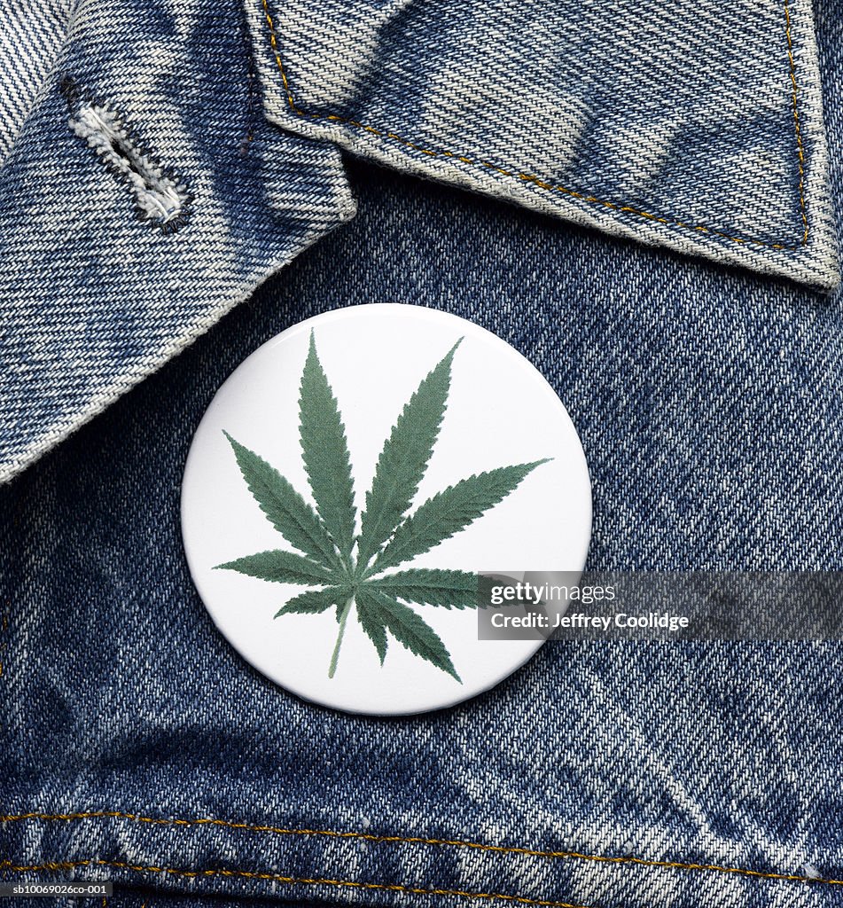 Marijuana button on denim jacket, close-up