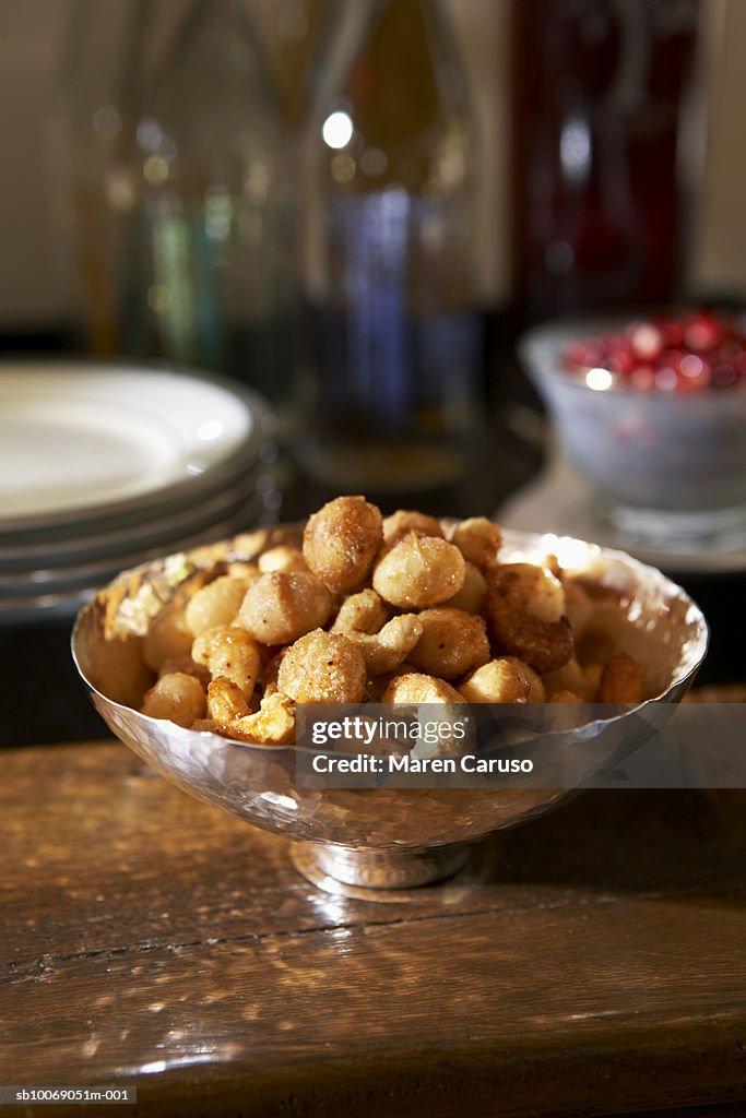 Cashew nuts and macadamia nuts in bowl on table, close-up