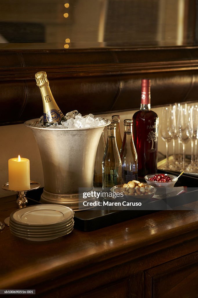 Champagne bottles in ice buckets with glasses on table