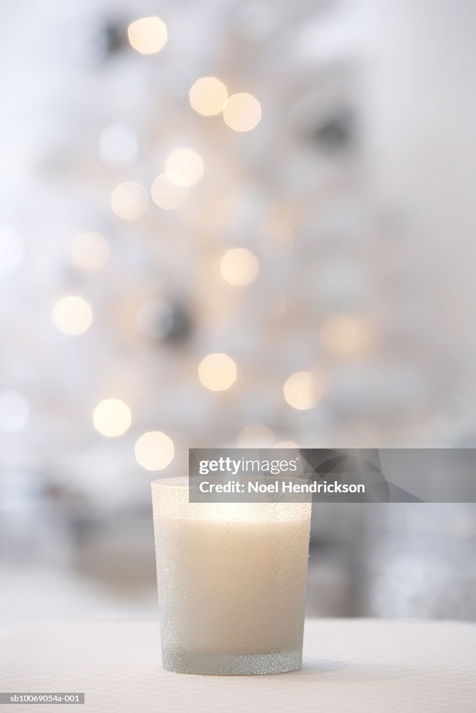 Votive candle in front of Christmas tree