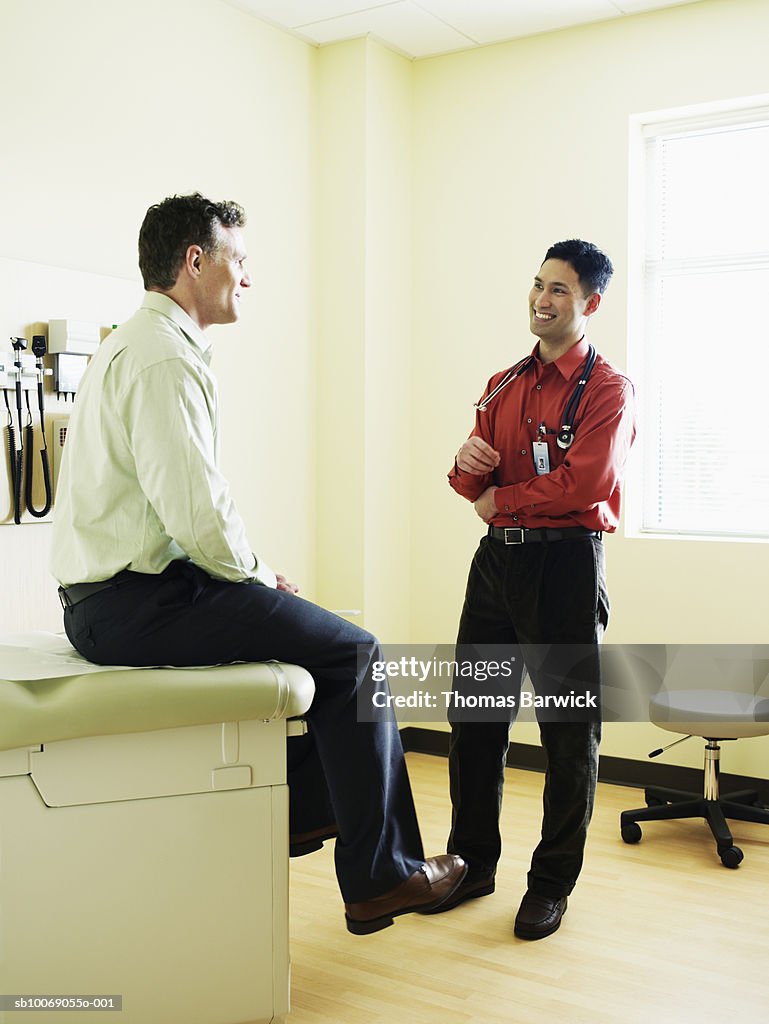 Doctor talking to patient in exam room