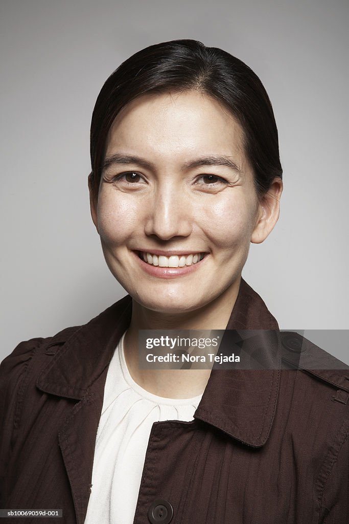 Studio portrait of mid adult woman smiling