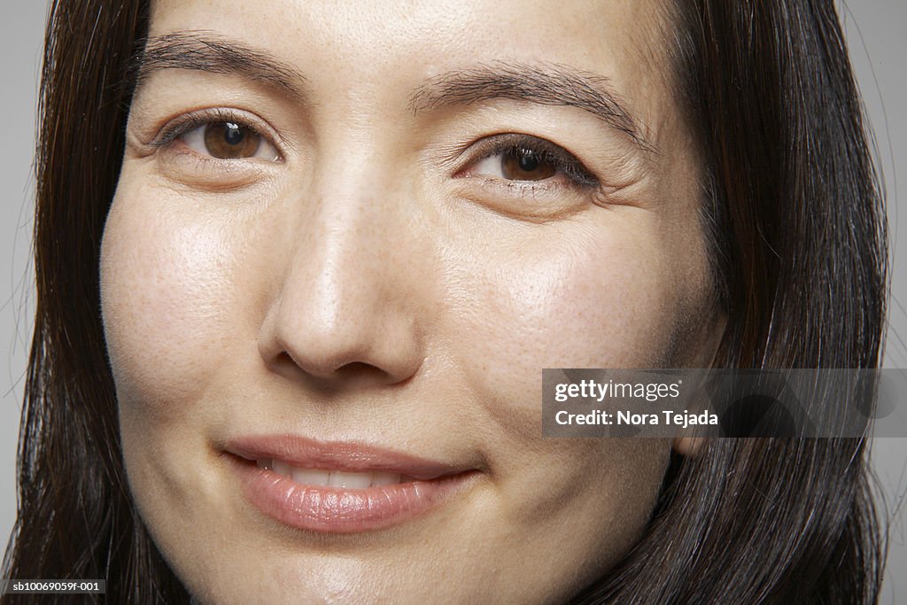 Studio portrait of mid adult woman, close-up