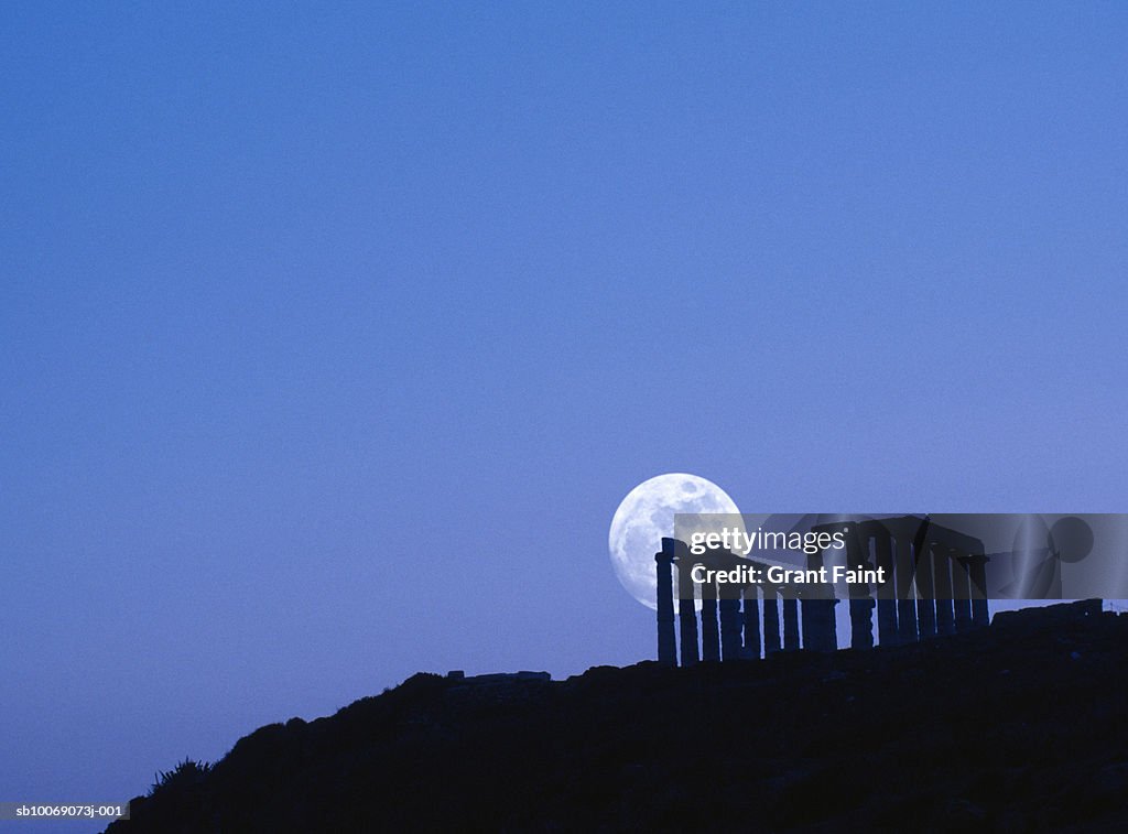 Greece, silhouette of Sounion temple with moon rise