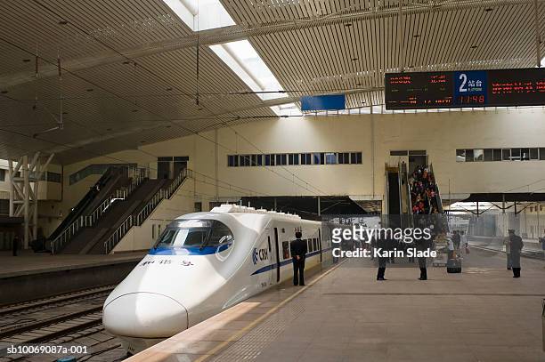 china, commuters on platform boarding china railway high speed train - china high speed rail stock pictures, royalty-free photos & images