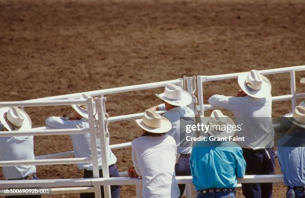 cowboys watching calgary stampede - calgary stampede stock pictures, royalty-free photos & images