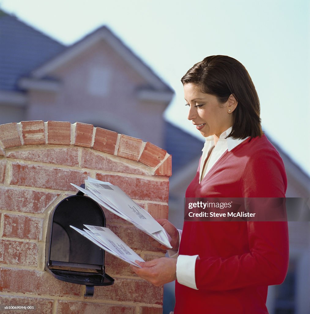 Woman getting mail from mailbox