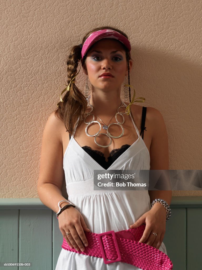 Young woman leaning on wall, portrait