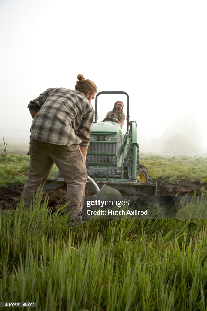 Farmers plowing field