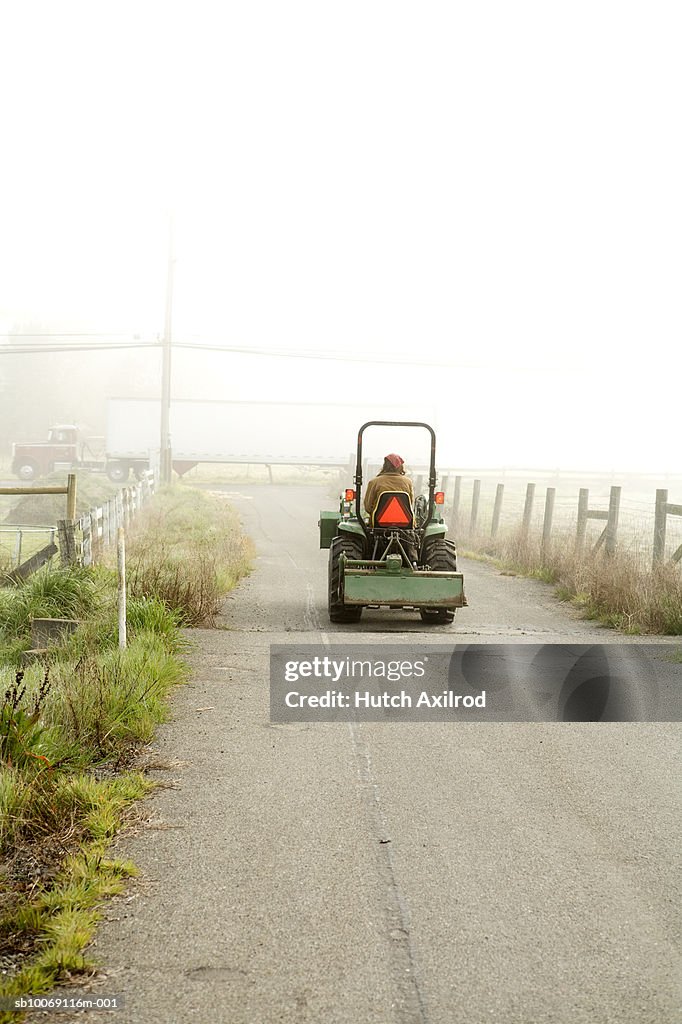 Farmer driving tractor