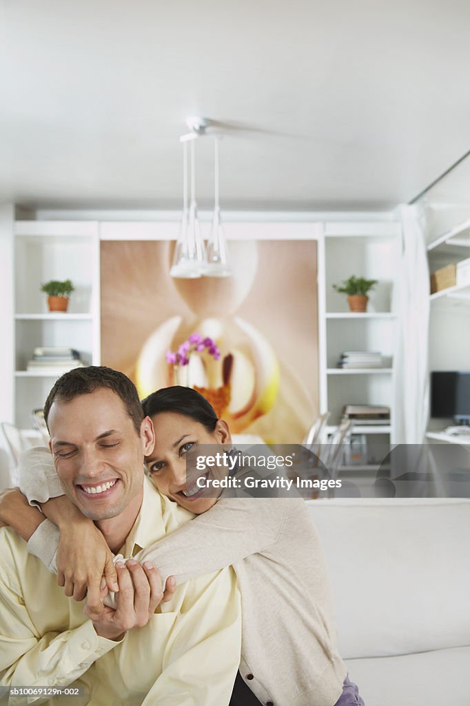 Woman embracing men, smiling