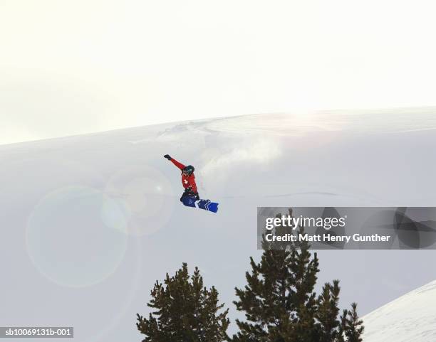 person jumping in mid-air on snowboard - bmw 3 stock pictures, royalty-free photos & images