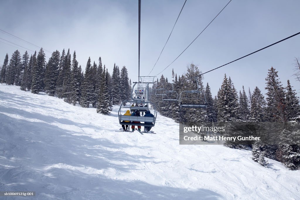 People travelling in cable car, rear view