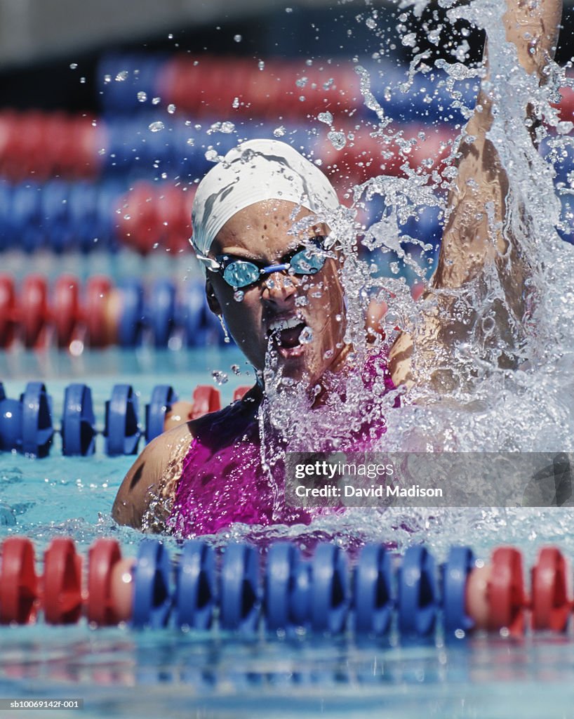 Female swimmer celebrating victory in swimming pool
