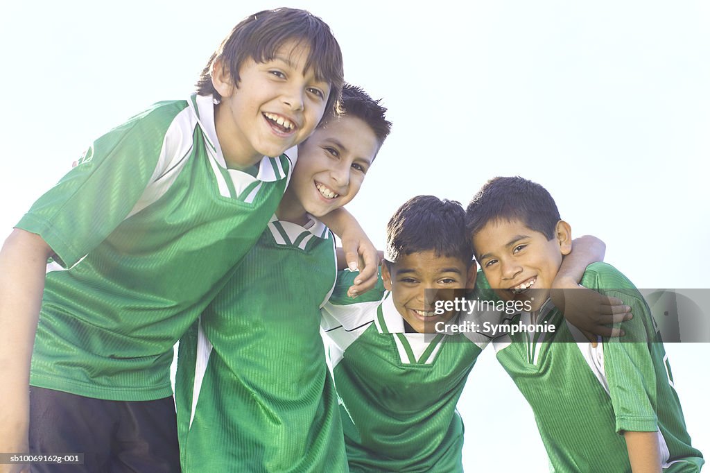 Boys wearing soccer uniform smiling, portrait