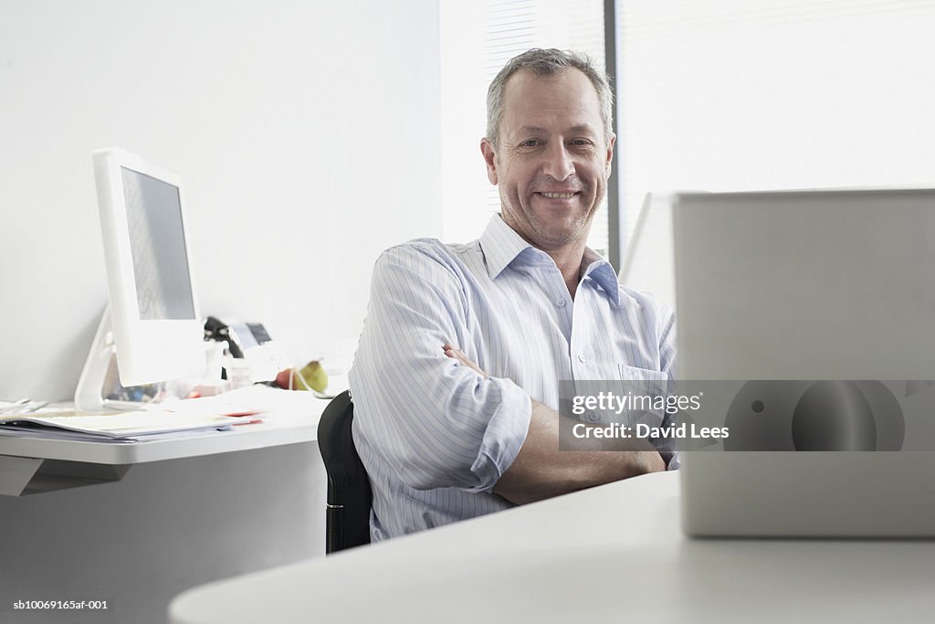 Portrait of man sitting in office