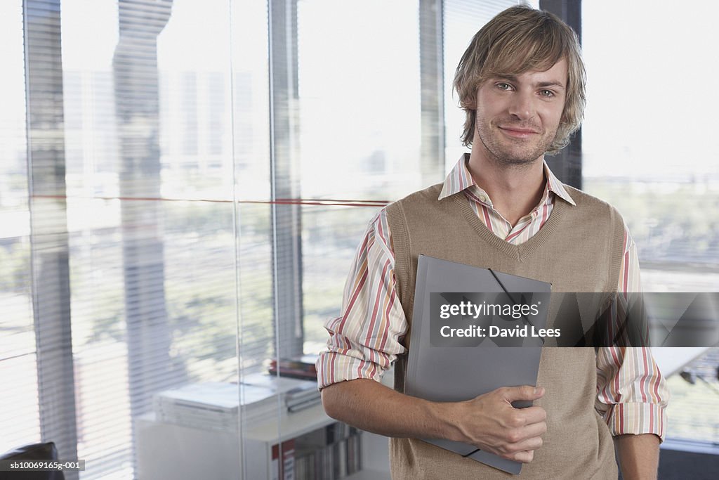 Portrait of young man in office