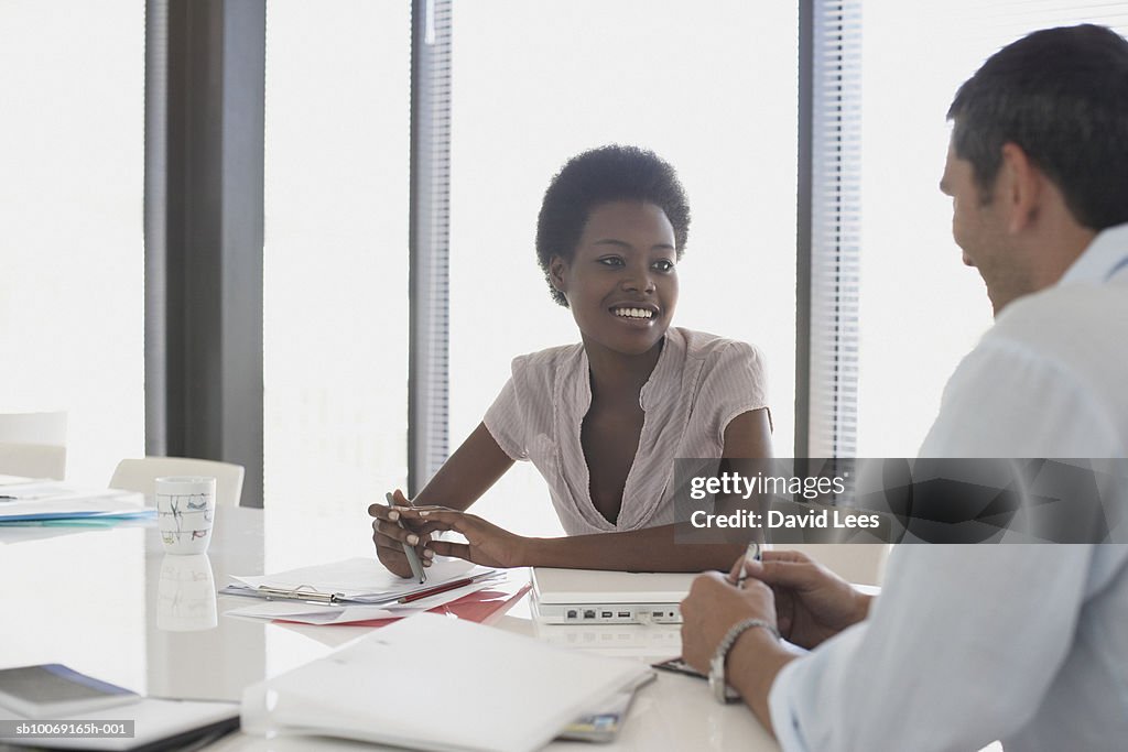 Man and woman talking in office