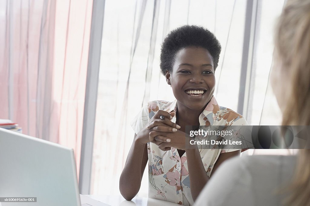 Two women talking in office