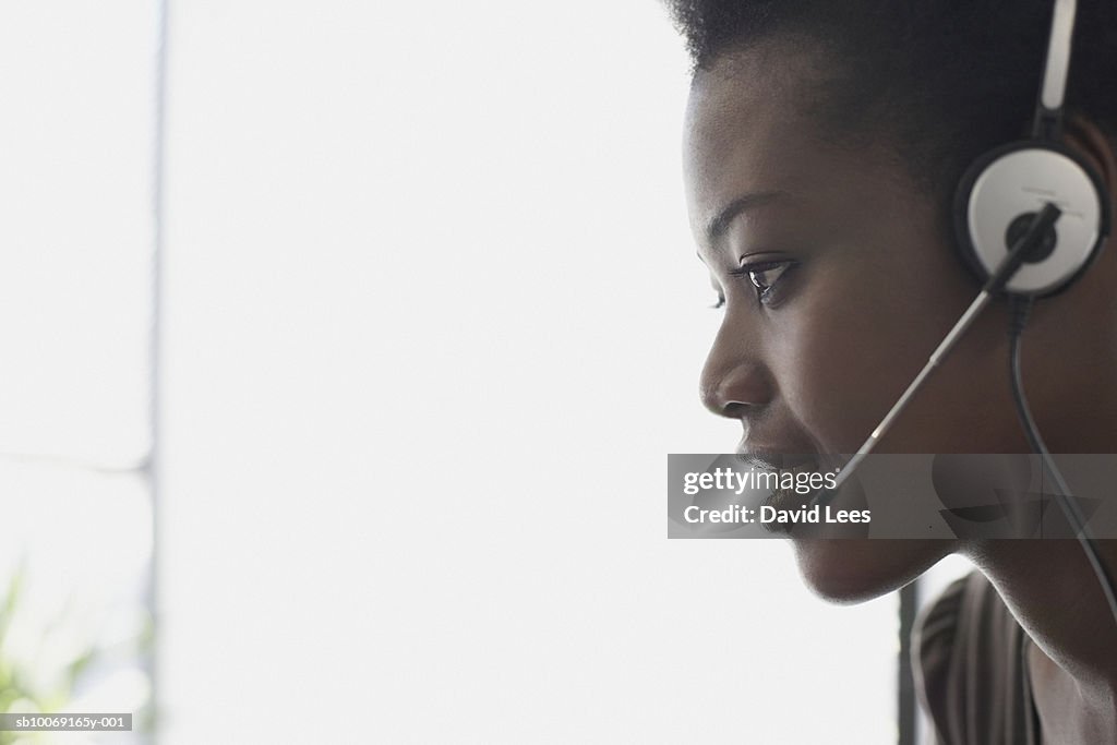 Woman wearing headset, profile, close-up