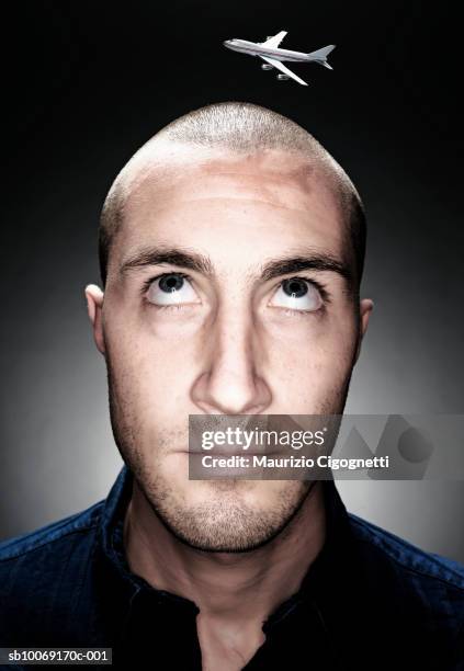 Small Flying Man Young Man With Miniature Airplane Flying Over Head Close Up Studio Shot ...