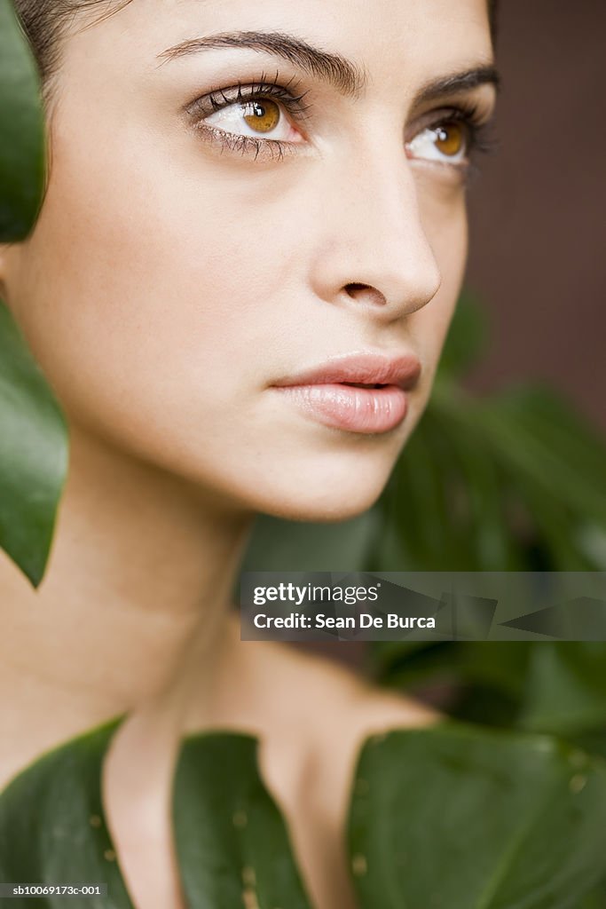 Young woman looking away, close up