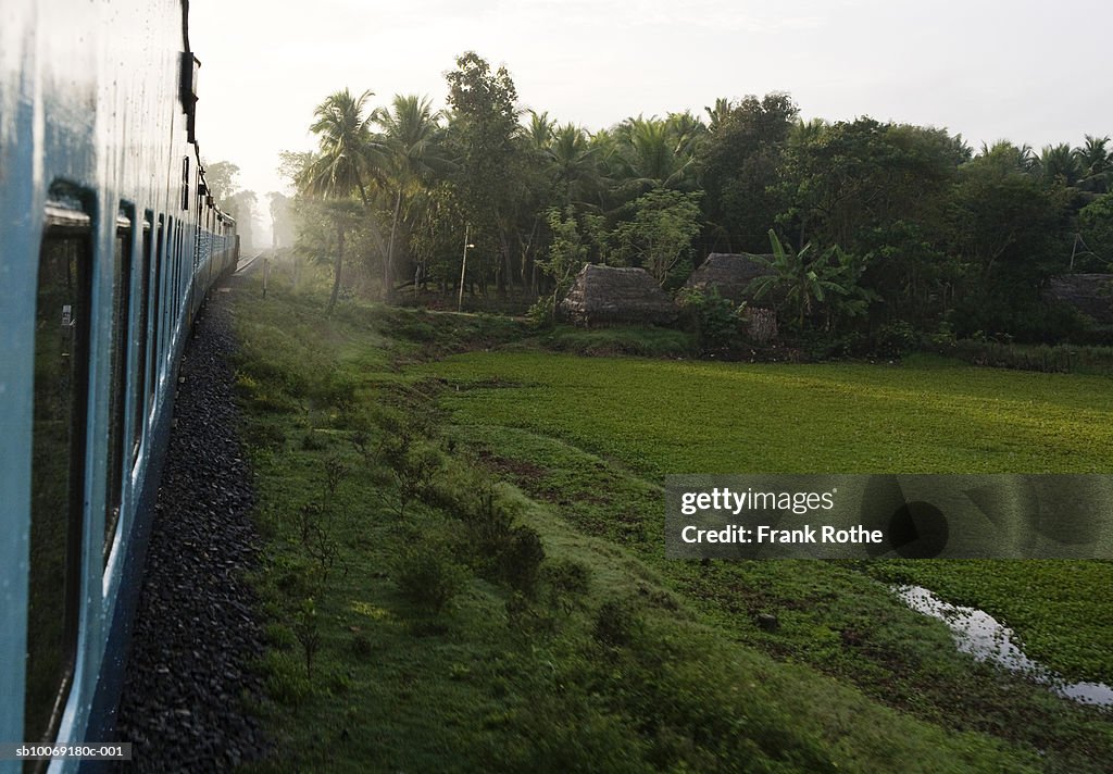 India, Train passing through field