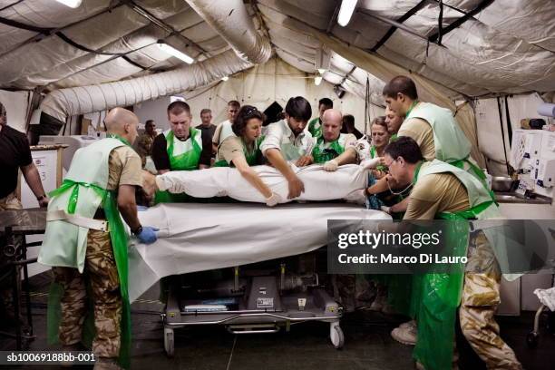 June 2007. British military medical personnel from the UK Med Group load Afghan National Army soldier Bashir into a bed in the RESUS at the British...