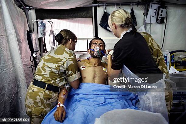 British Army Intensive care nurses attend Afghan National Army soldier Sgt. Sardar in the Intensive care unit after surgery at the British Army Field...