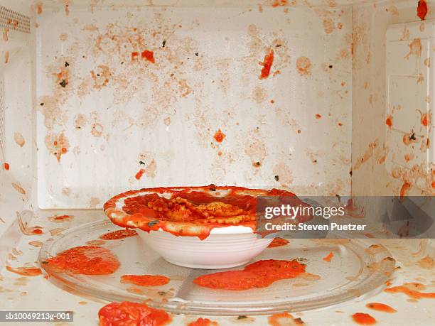 food splattered in microwave oven, close-up - microwave stock pictures, royalty-free photos & images