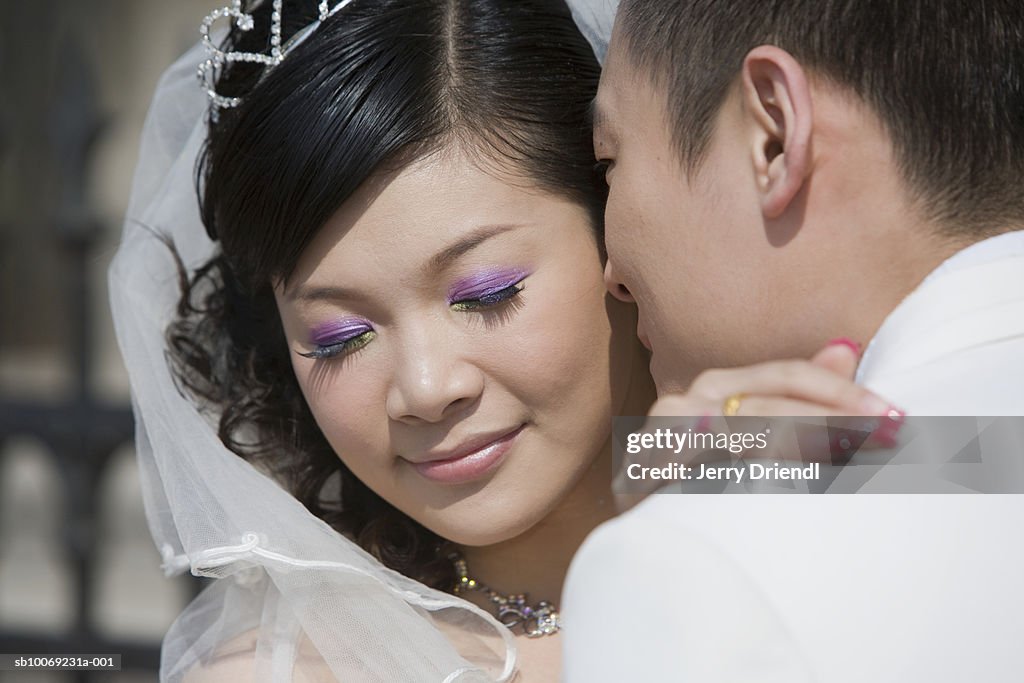 Wedding couple hugging outdoors