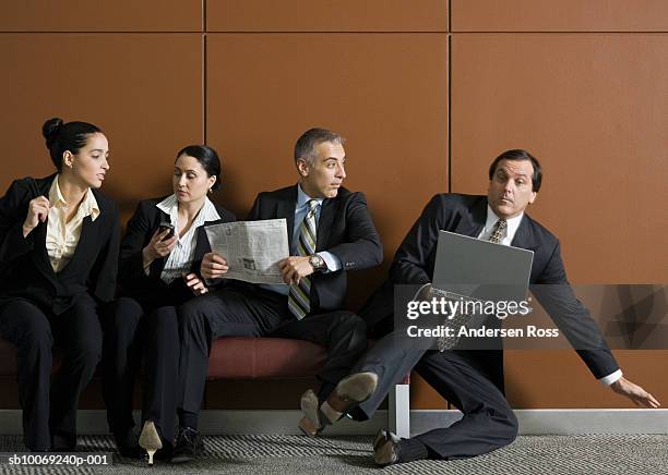 business man with laptop getting pushed off from bench by businesspeople - pushing away stock pictures, royalty-free photos & images