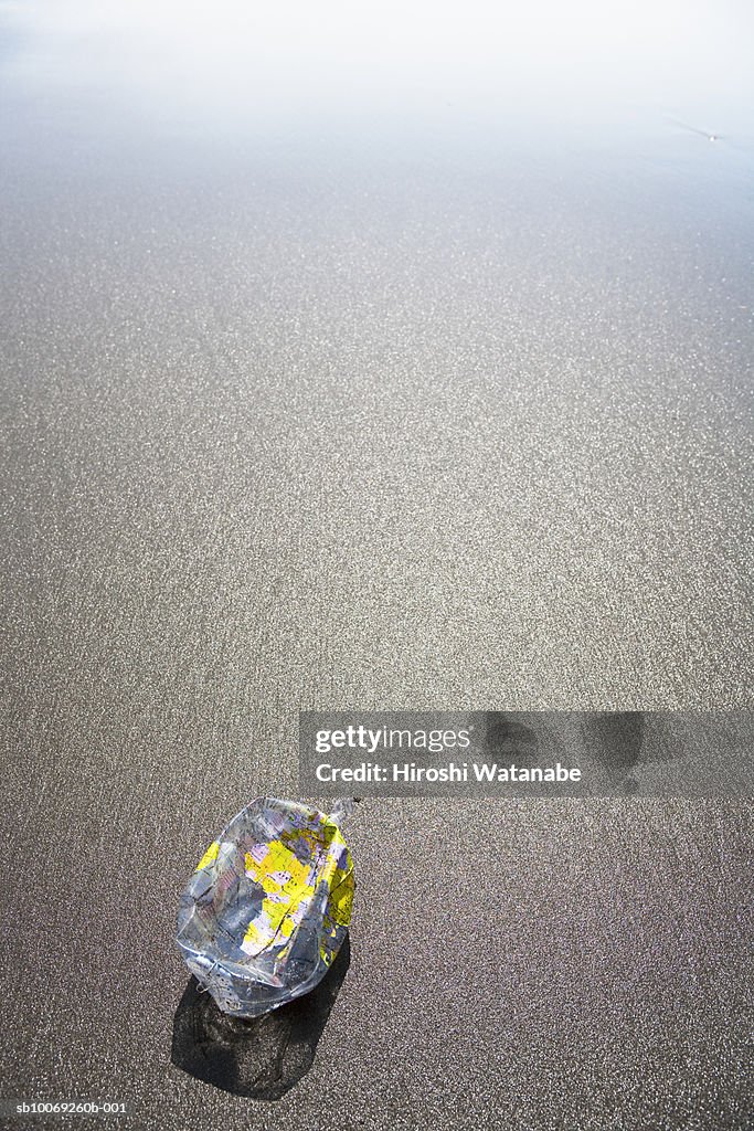 Deflated globe on beach (high angle view)