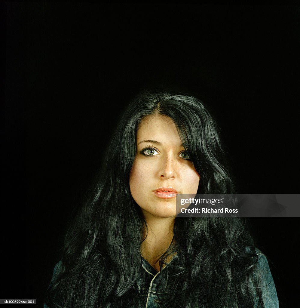 Studio portrait of young woman with long black hair