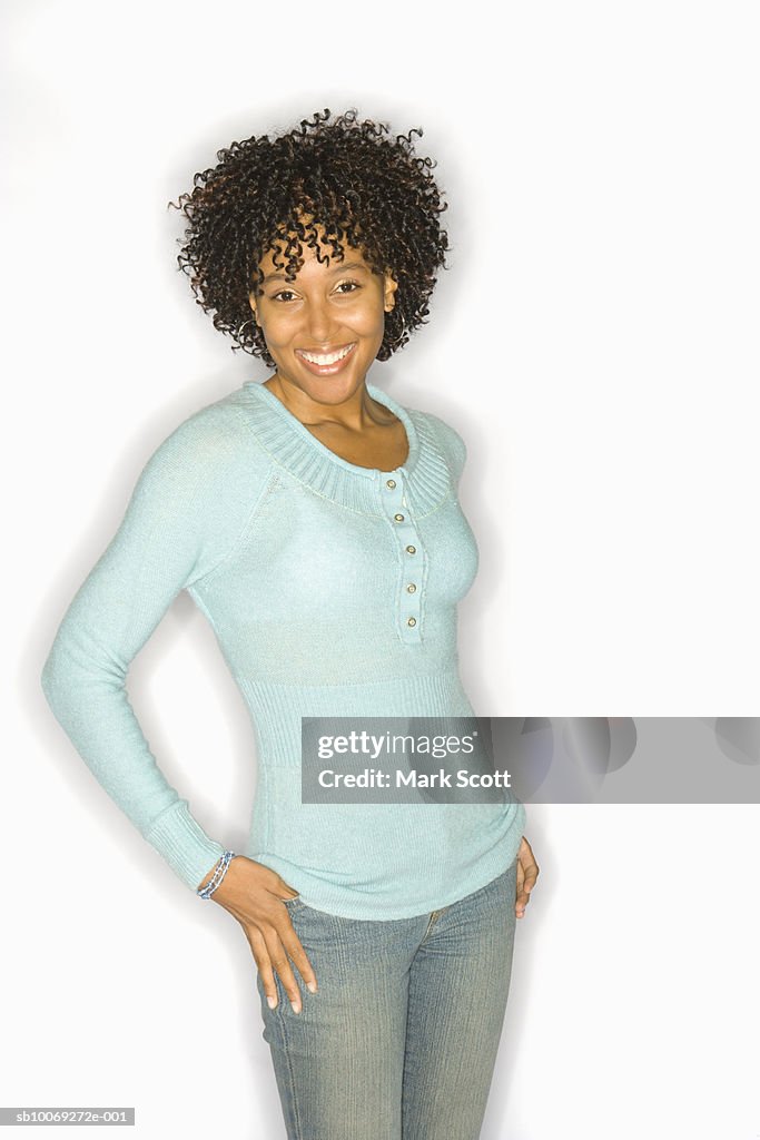 Portrait of young woman smiling, studio shot