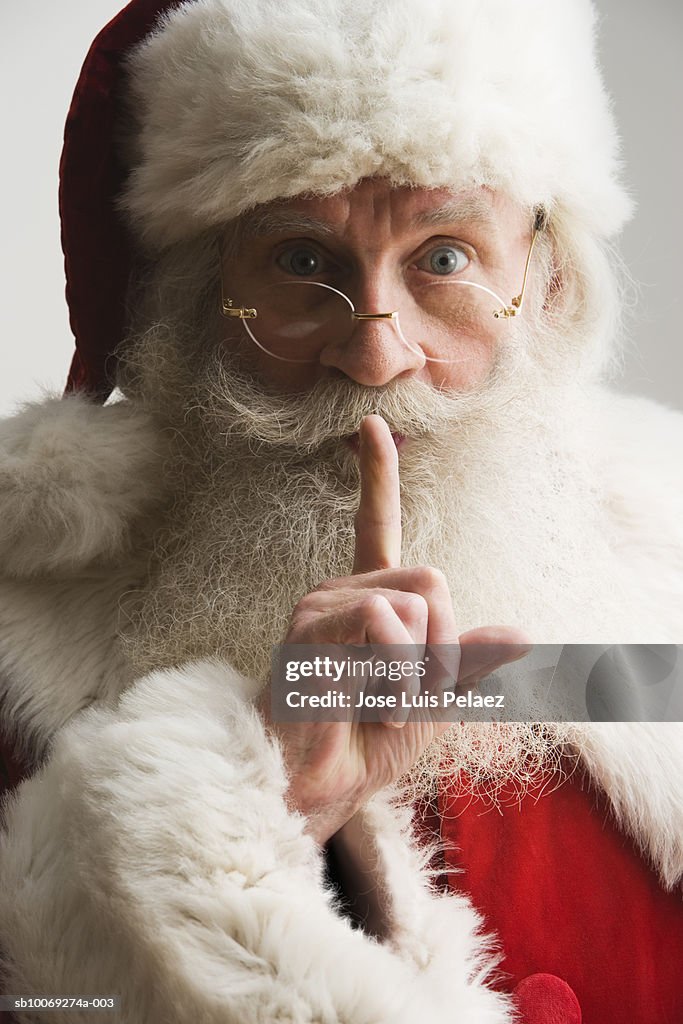 Santa Clause with finger on lips, portrait, close-up