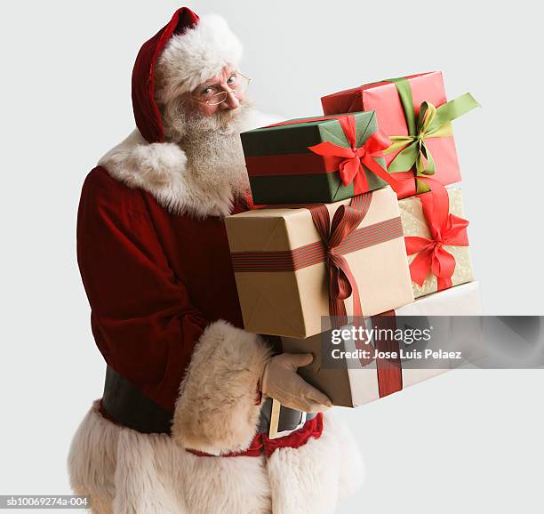 santa clause carrying presents, portrait, close-up - santa close up stock-fotos und bilder