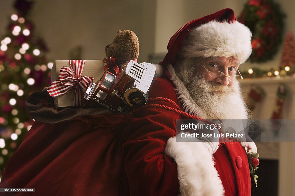 Santa Claus carrying sack of gifts, portrait, close-up