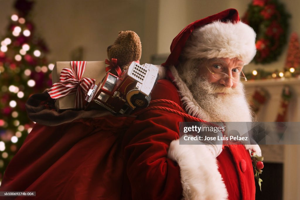 Santa Claus carrying sack of gifts, portrait, close-up