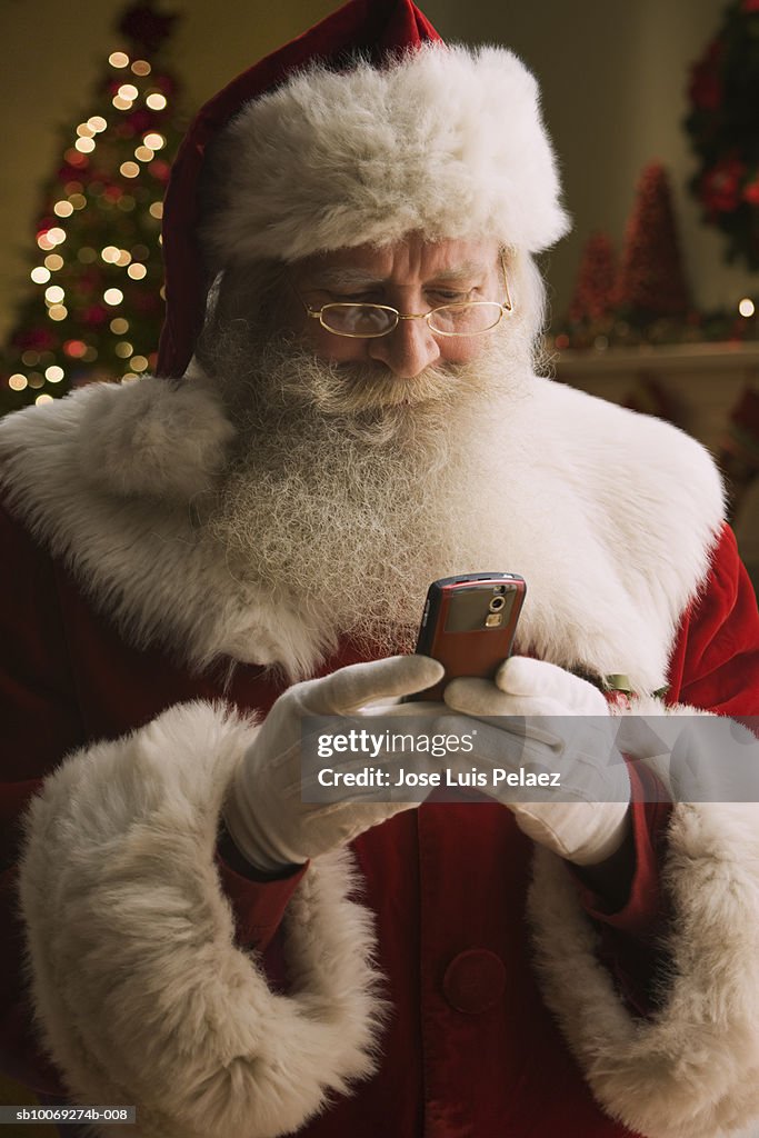 Santa Claus text messaging, close-up