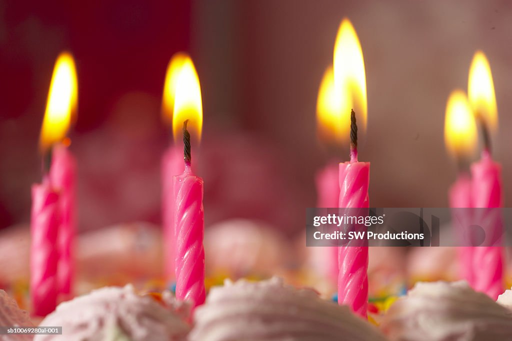 Birthday cake with burning candles, close-up
