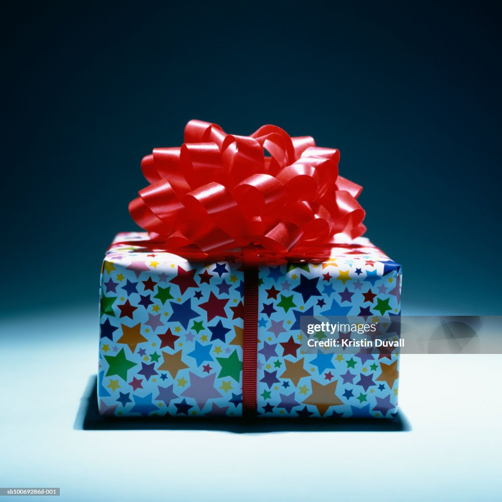 Wrapped gift with red bow, studio shot