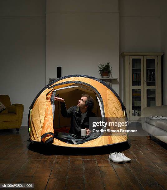 man sitting in tent in living room - the comedy tent stock pictures, royalty-free photos & images