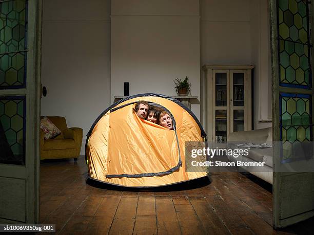 three friends peering from tent in living room - the comedy tent stock pictures, royalty-free photos & images