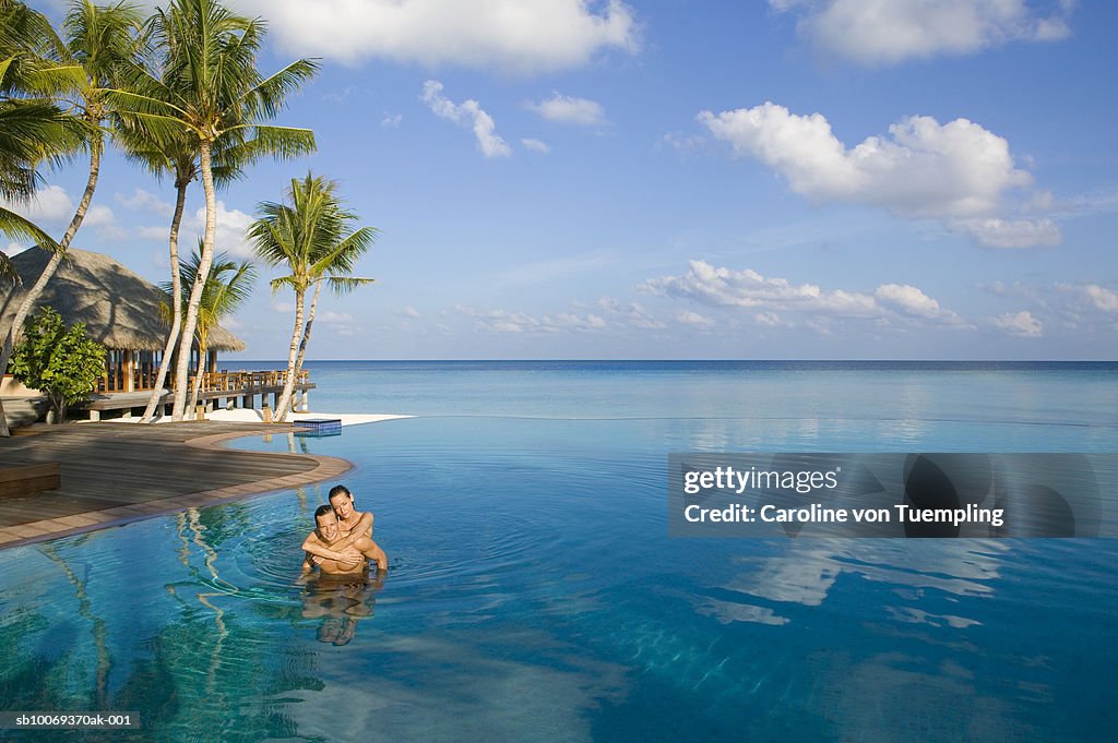 Young couple in swimming pool, high angle view