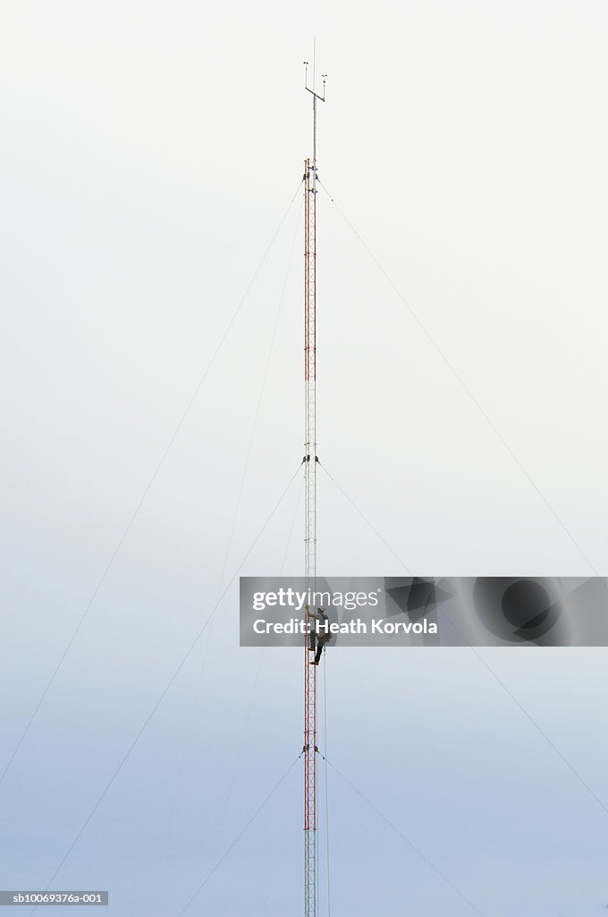 Man climbing meteorological tower