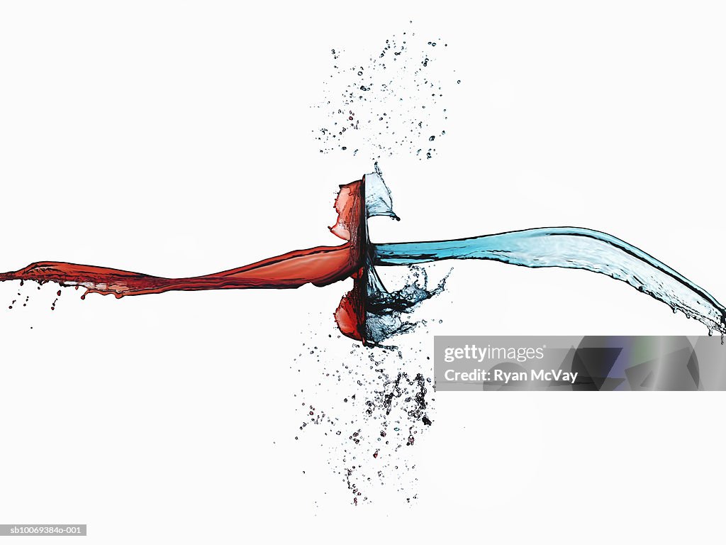 Two splashes of colored liquid colliding, studio shot