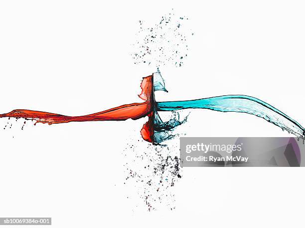 two splashes of colored liquid colliding, studio shot - confrontation stock pictures, royalty-free photos & images