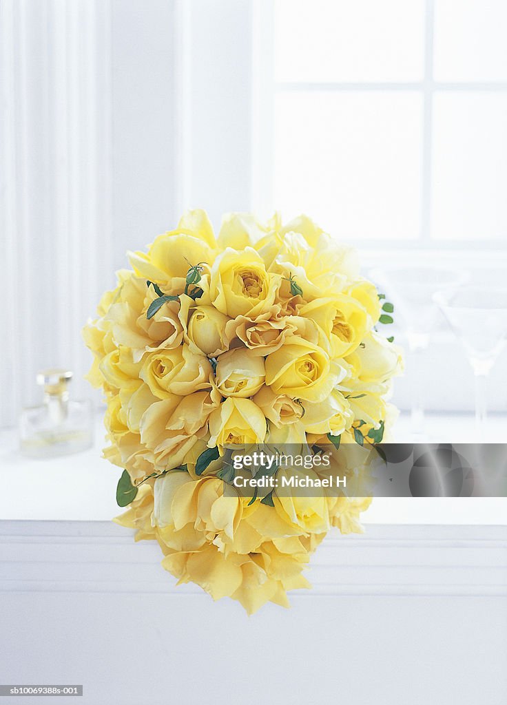 Bouquet of yellow rose and jasmine by window
